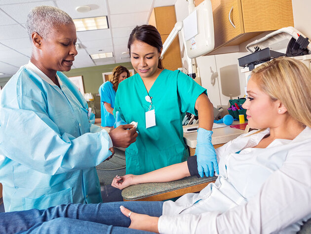 Student nurse and teaching nurse with patient
