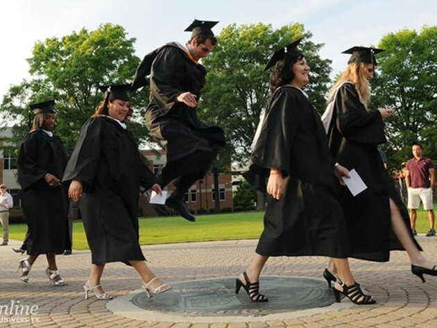 ODU graduates crossing the seal on Kaufman Mall