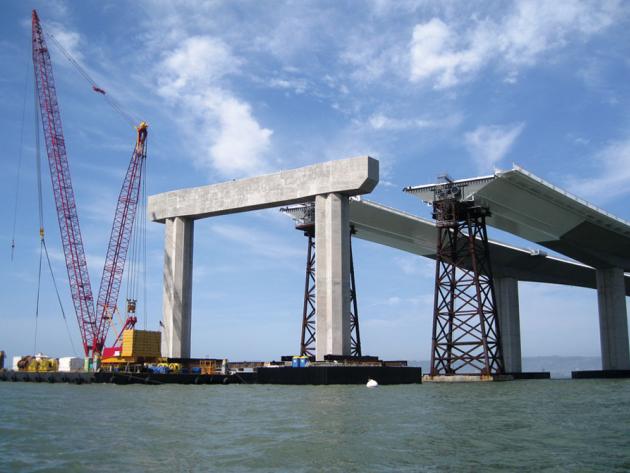 A coastal bridge under construction by civil engineers.