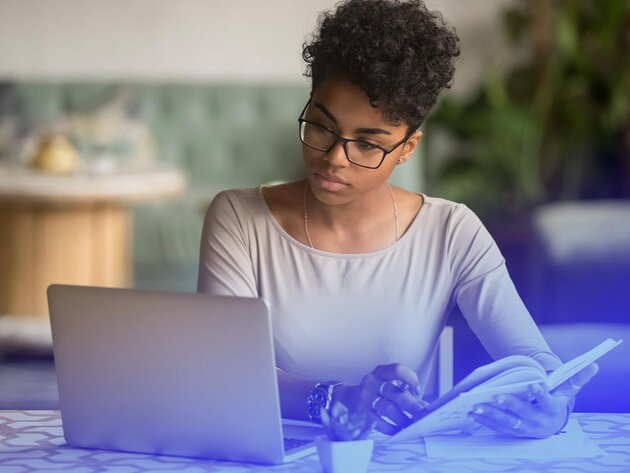 Woman researching online degree programs on her laptop