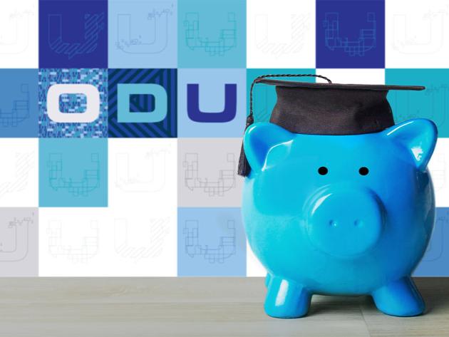 A blue ceramic piggy bank wears a college graduation cap to illustrate paying for college with scholarships.