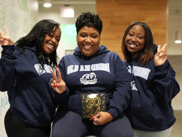 ODU alumnae Jordyn Harrell, left, and Jasmyn Harrell flank their mother Celeste Harrell, who is scheduled to graduate from ODU in May 2023.