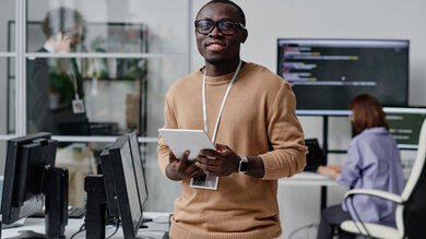 IT specialist working online on digital tablet